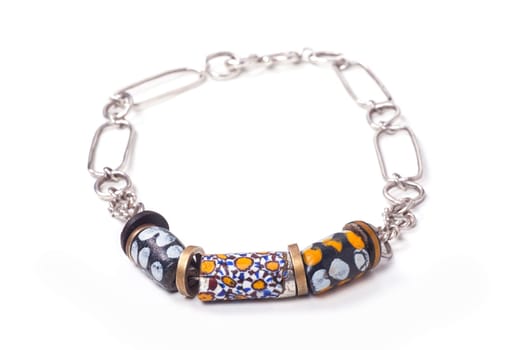 Close up of silver and painted stone necklace isolated on white background, manufactured by Ornella Salamone