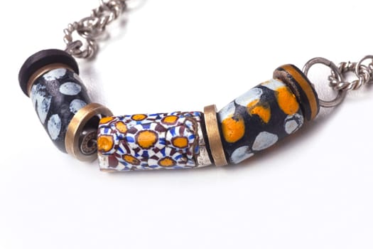 Close up of silver and painted stone necklace isolated on white background, manufactured by Ornella Salamone