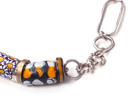 Close up of silver and painted stone necklace isolated on white background, manufactured by Ornella Salamone