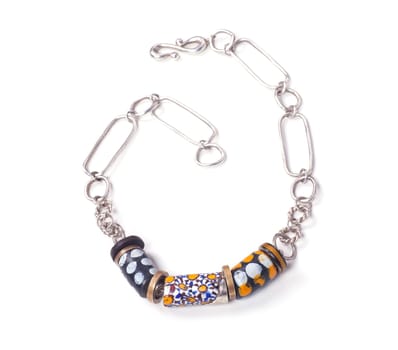 Close up of silver and painted stone necklace isolated on white background, manufactured by Ornella Salamone