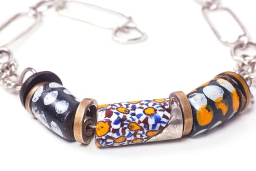 Close up of silver and painted stone necklace isolated on white background, manufactured by Ornella Salamone
