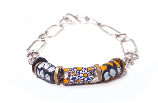 Close up of silver and painted stone necklace isolated on white background, manufactured by Ornella Salamone
