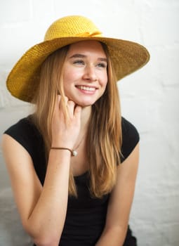 Young blonde girl wearing a straw hat