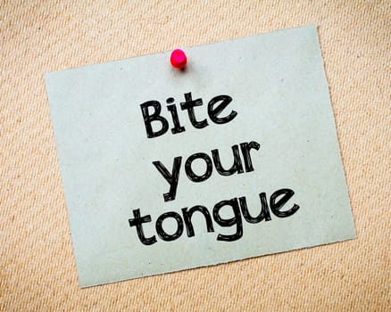 Be careful what you wish for Message. Recycled paper note pinned on cork board. Concept Image