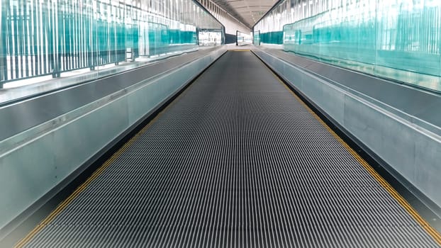 Modern walkway of escalator move forward and escalator move backward in international airport. Escalator is facility for support transportation