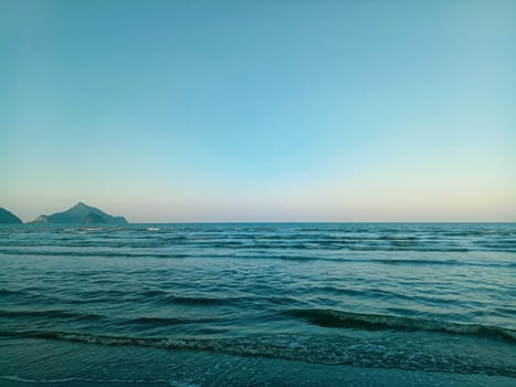 Sea and mountains landscape with blue gradient color. Summer holiday idea nature background
