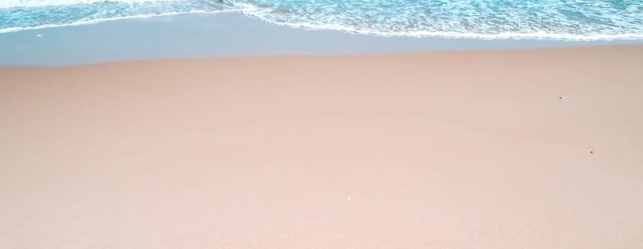 Sand on tropical beach on summer season. Simple beach background for summer. Bubble blue wave from sea to sand on the beach. Summer background.