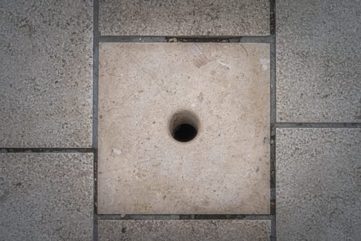 Exit tube of Sea organ, Morske Orgulje, in pavement, architectural sound art object which plays music by way of sea waves and tubes located underneath