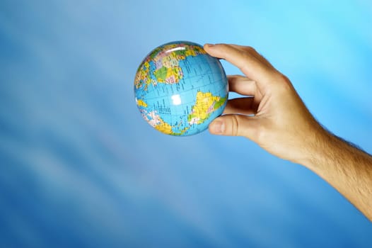 Close-up of a manŽs hand holding a globe