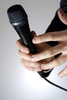 Close-up of a manŽs hand holding a microphone