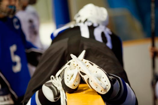 Rear view of an ice hockey player lying on a railing