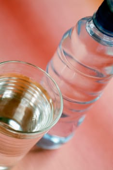 Close-up of a glass of water with a water bottle