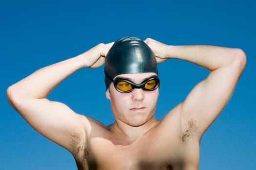 Close-up of a young man wearing a swimming cap