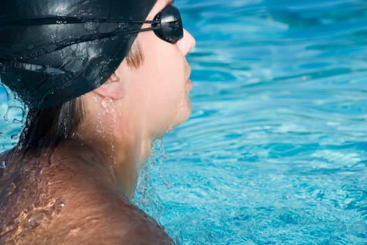 Close-up of a young man swimming in a swimming pool