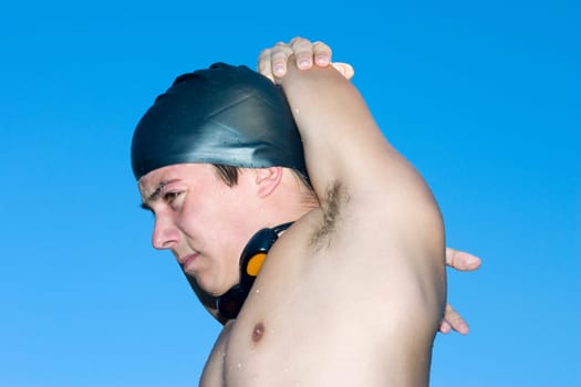 Close-up of a young man stretching his arms