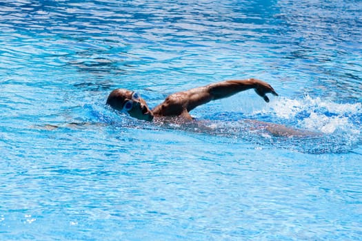 Mid adult man swimming in a swimming pool