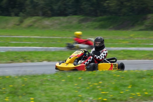 Person go-carting on a motor racing track