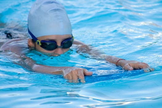 Close-up of a young woman swimming in a swimming pool