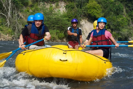 Five people rafting in a river