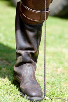 Close-up of a personŽs leg wearing a riding boot