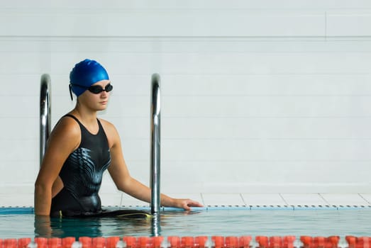 Close-up of a teenage girl standing in a swimming pool