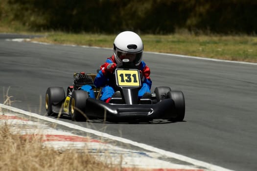 Person go-carting on a motor racing track