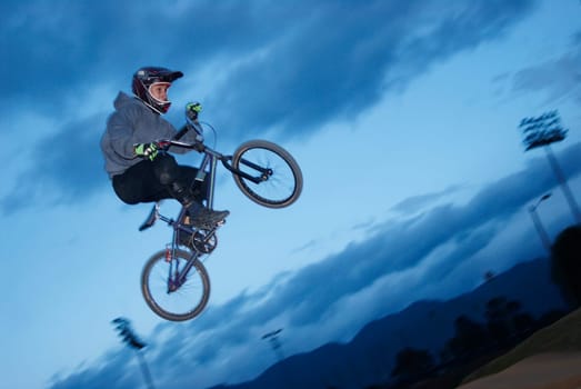 Low angle view of a BMX cyclist performing in mid_air