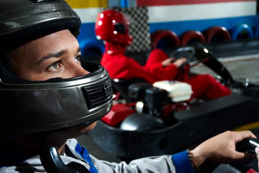 Close_up of a male go_cart racer in a sports car
