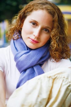 Portrait of a young woman hugging her knees