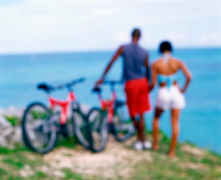 Rear view of a young couple standing with bicycles on the coast, Bermuda