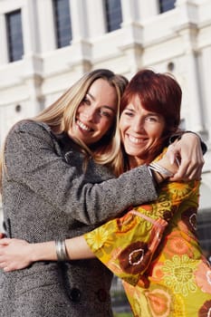 Portrait of two young women hugging each other