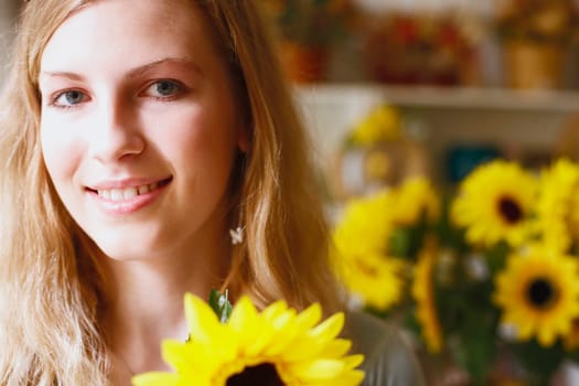 Portrait of a young woman holding a flower