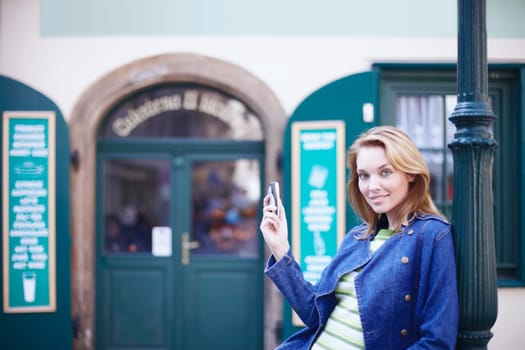 Portrait of a young woman holding a mobile phone