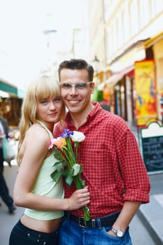 Portrait of a young woman and a mid adult man standing on the street