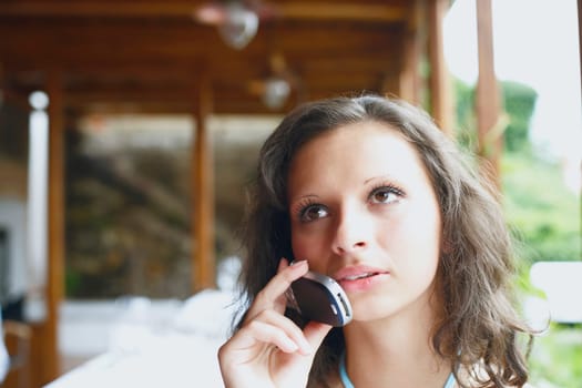 Close-up of a young woman talking on a mobile phone