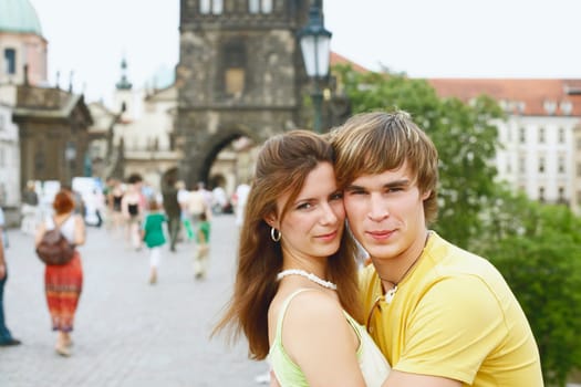 Side profile of a young man embracing a young woman