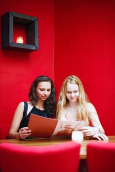Two young women sitting in a restaurant