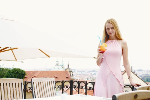 Portrait of a young woman holding a drink