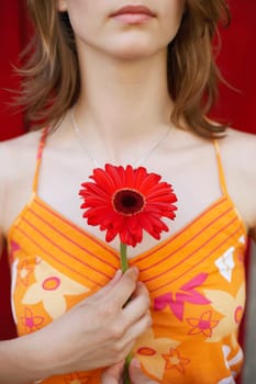 Close-up of a teenage girl holding a flower