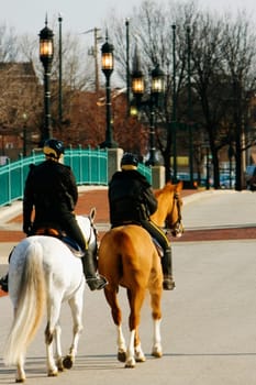 Rear view of two people riding horses, Baltimore, Maryland, USA