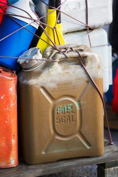 Close-up of oil cans tied up with a string