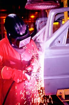 Welder working on car doors in an assembly line, Newark, Delaware, USA