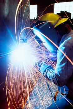 Welder welding a large tank, Chicago, Illinois, USA