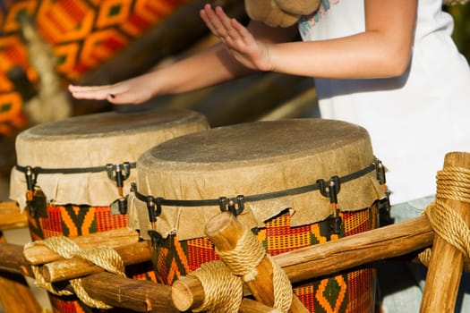 Mid section view of a woman playing drums