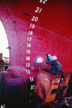 Rear view of a welder welding a tanker, Cebu, Philippines