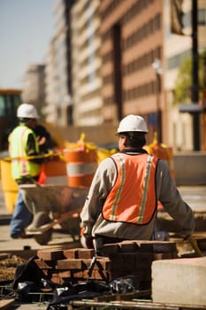 Two construction workers working at a construction site