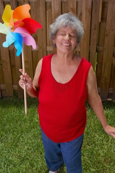 Close-up of a senior woman holding a pinwheel