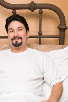 Portrait of a mid adult man reclining on the bed