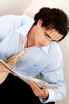 Close-up of a businessman reading a newspaper