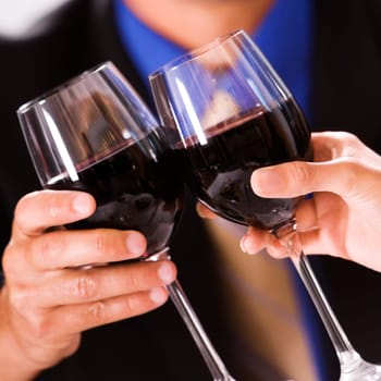 Close-up of two people toasting with wineglasses